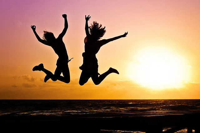 two people jumping in the air`